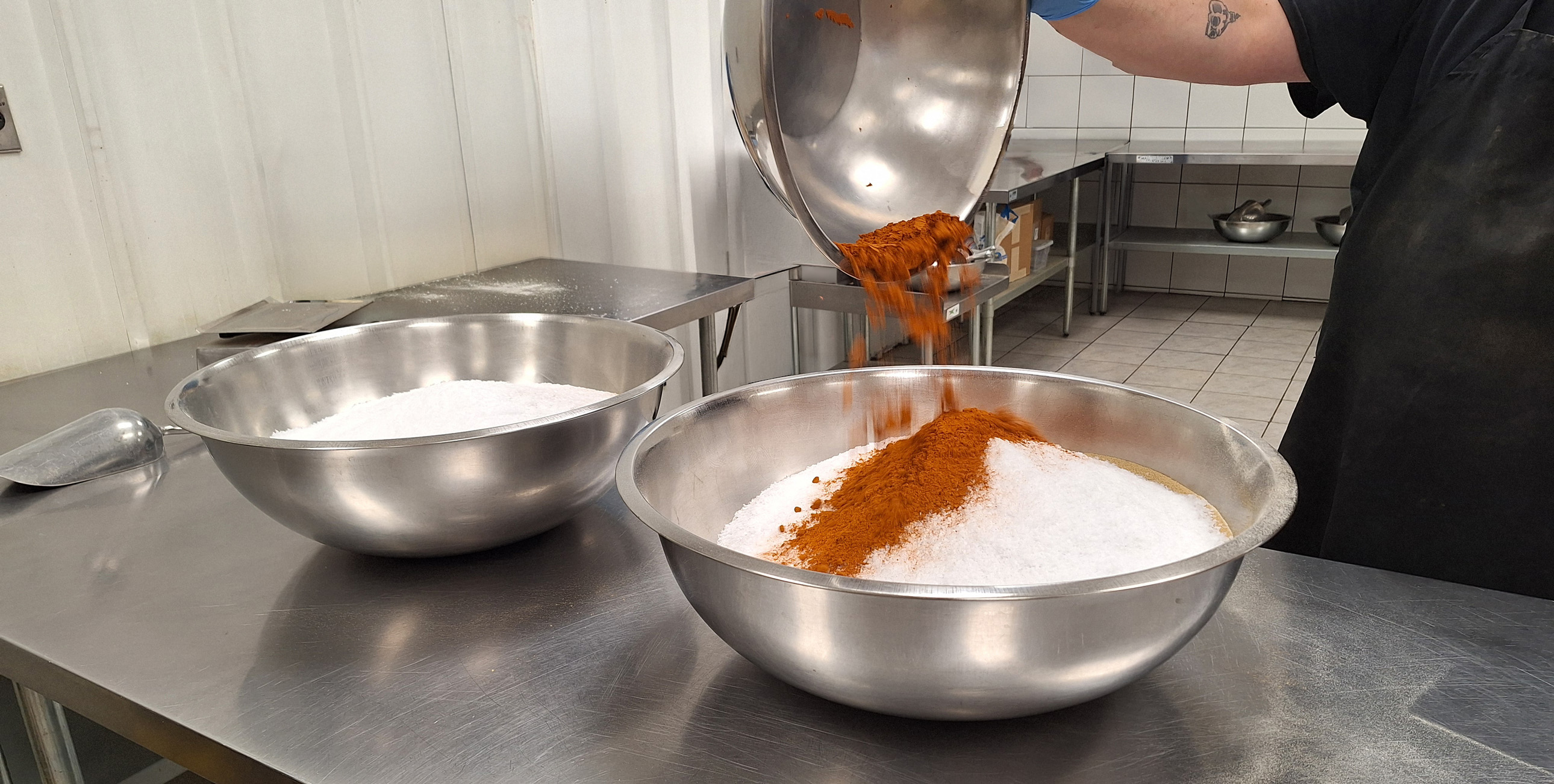 Pouring Spices Into Bulk Blend